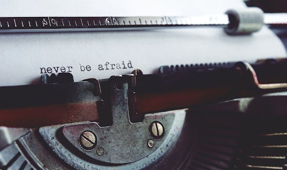 Close-up of a vintage typewriter with the message 'never be afraid' on paper.