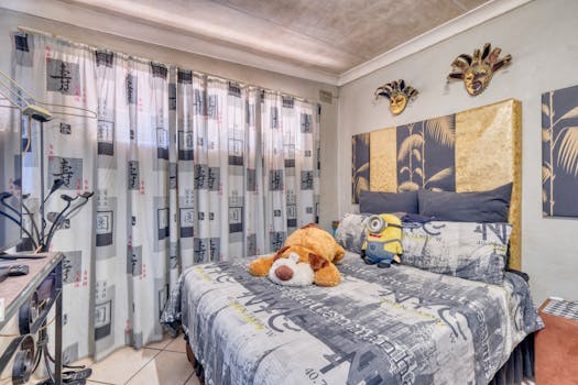 Inviting bedroom interior with stuffed toys, unique decor, and soft lighting.